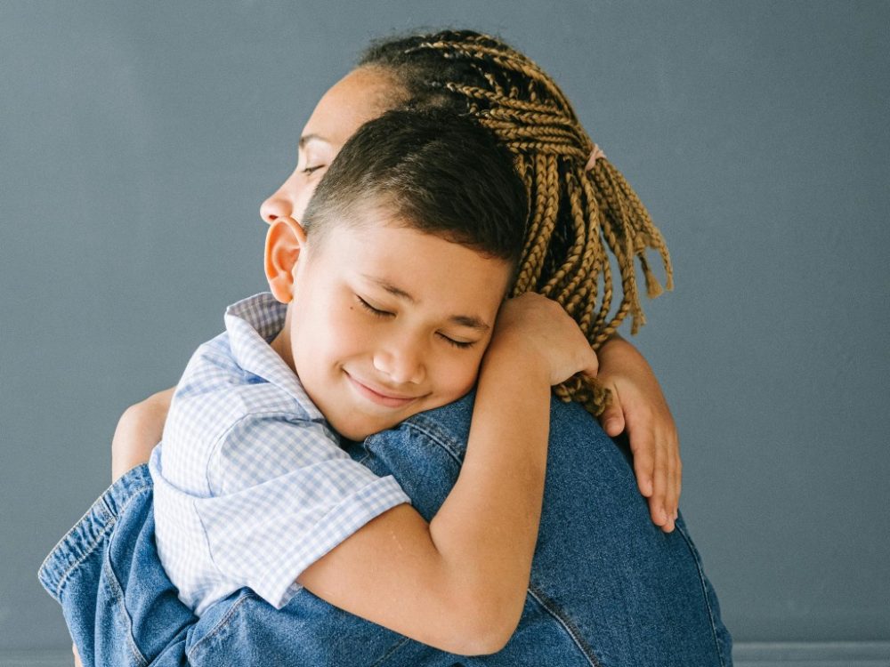 Mother hugging her son, mother's compassion and love,