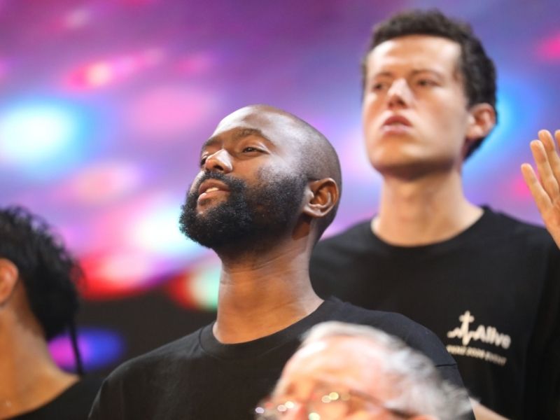Men sing praise to God at Promise Keepers Alive in Christ Event in Auckland at Church Unlimited