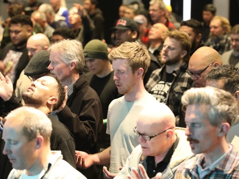 Men at Promise Keepers singing worship to God, bless His holy name,