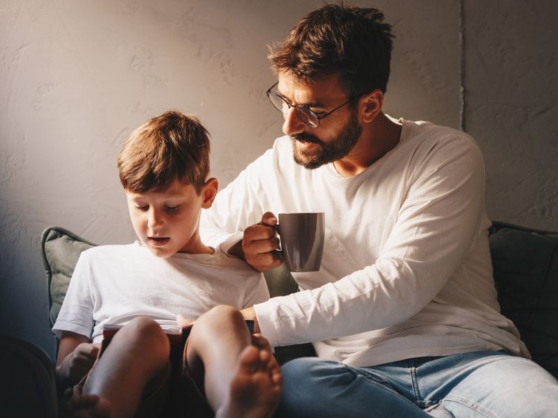 Father and son reading together